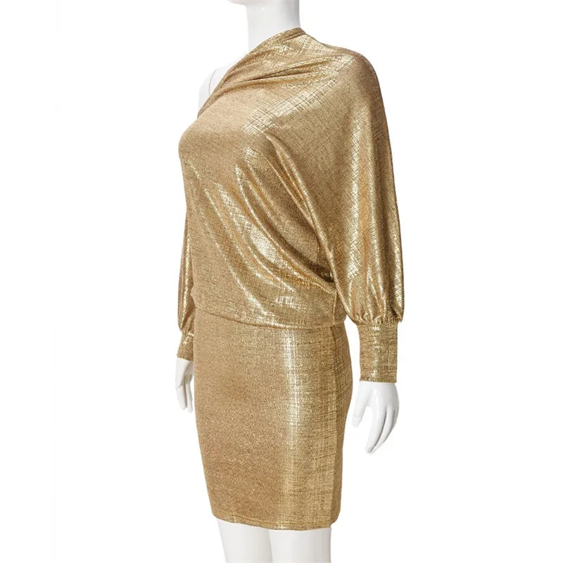 Gold metallic dress on a mannequin against a white background