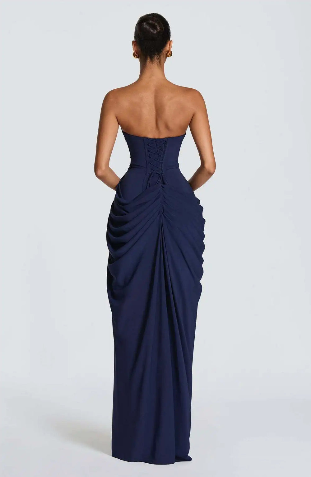 Navy strapless gown with draped design on a white background
