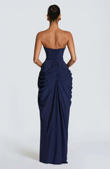 Navy strapless gown with draped design on a white background