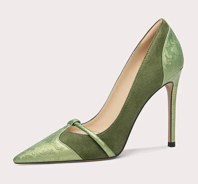 Green high-heeled shoe on a white background