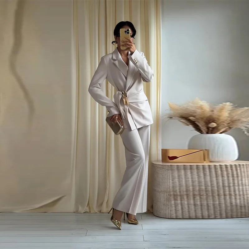 Solid draped blazer and wide leg pants set with gold belt and clutch