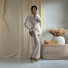 Solid draped blazer and wide leg pants set with gold belt and clutch