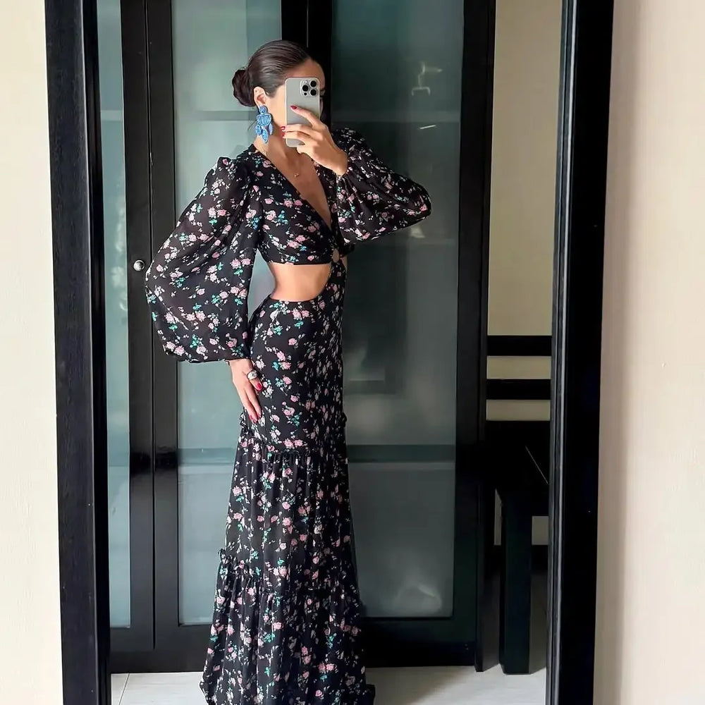 Woman taking a mirror selfie wearing a floral dress.