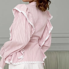 Pink lace-trimmed garment on a neutral background