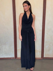 Black halter neck draped maxi dress against a neutral background