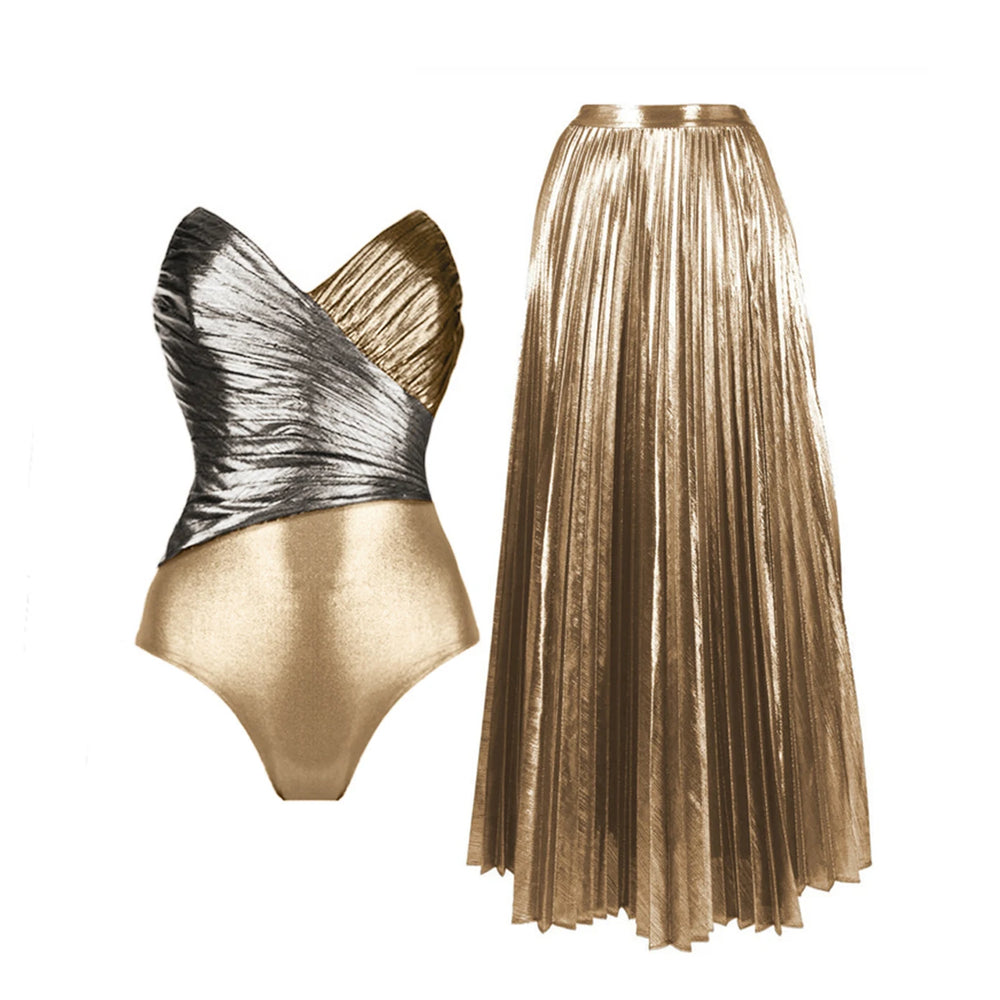 Metallic one-shoulder ruffled bodysuit with black briefs and a gold pleated maxi skirt
