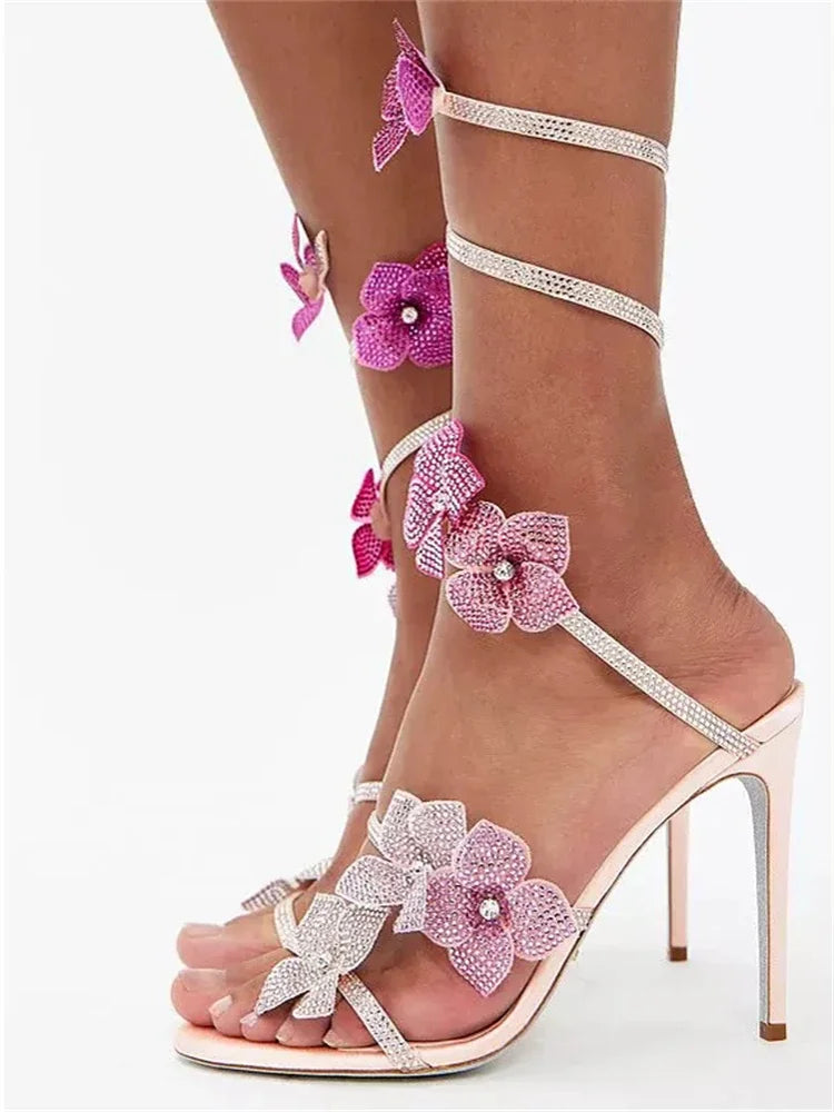 Crystal flower ankle strap stiletto heels on a white background