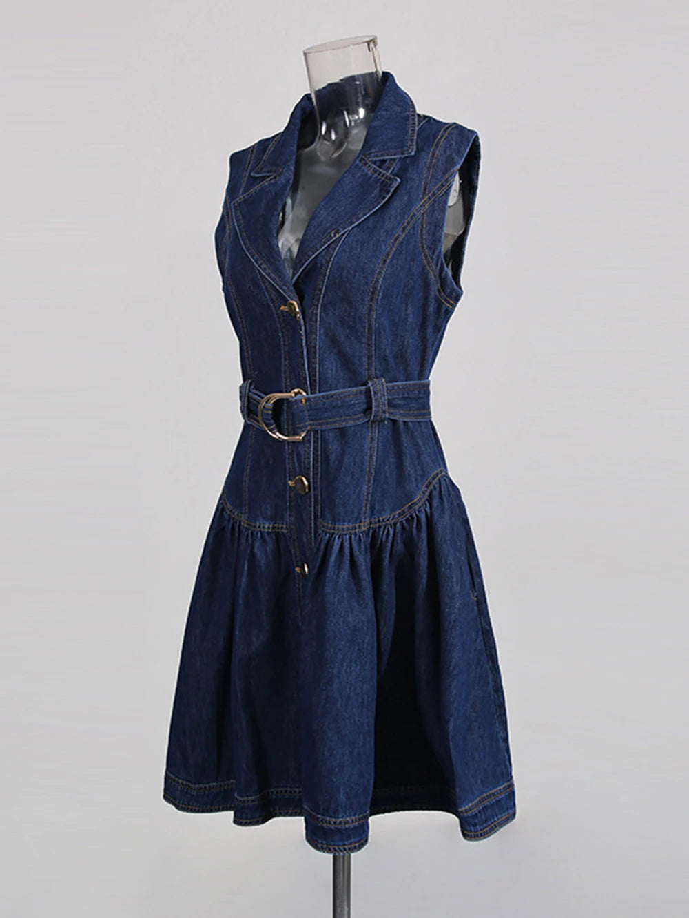 Denim dress on a mannequin against a gray background