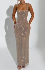Woman wearing a sparkly beige dress against a white background