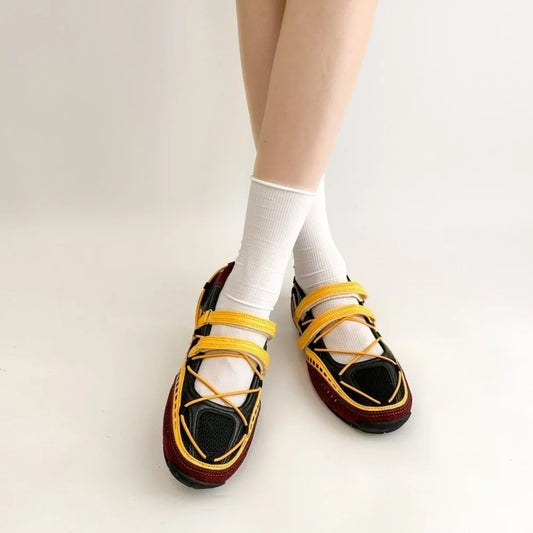Pair of red mesh Mary Jane shoes with hook and loop straps.