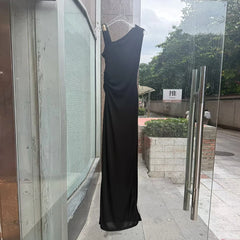 Black one-shoulder ruched maxi dress displayed in storefront
