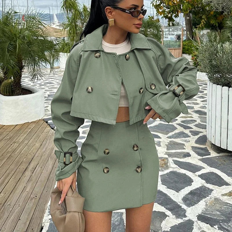 Woman wearing a green outfit with buttons on a stone pathway.