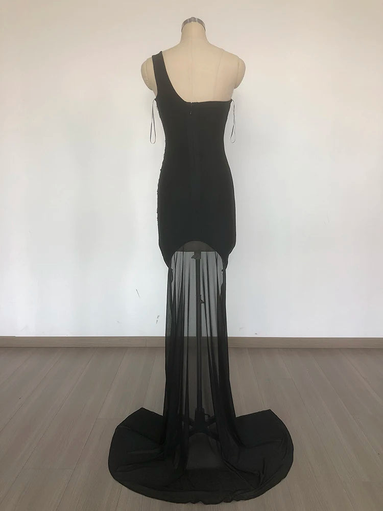 Black evening gown on a mannequin against a white background