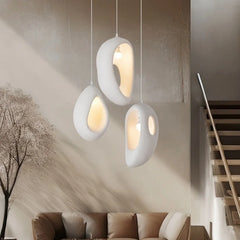 White sculptural Wabi Sabi LED pendant light with organic shade in a serene modern living room