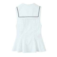 White sleeveless dress with black trim on a white background