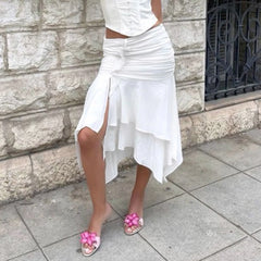 Detail shot of an asymmetrical ruched slit midi skirt showing fabric texture.