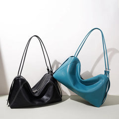 Black and blue soft leather pillow shoulder bags side-by-side