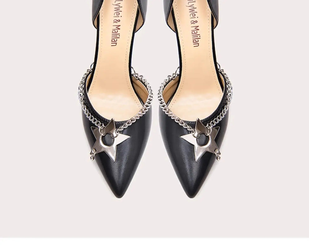 Black high-heeled shoes with star and chain details on a white background