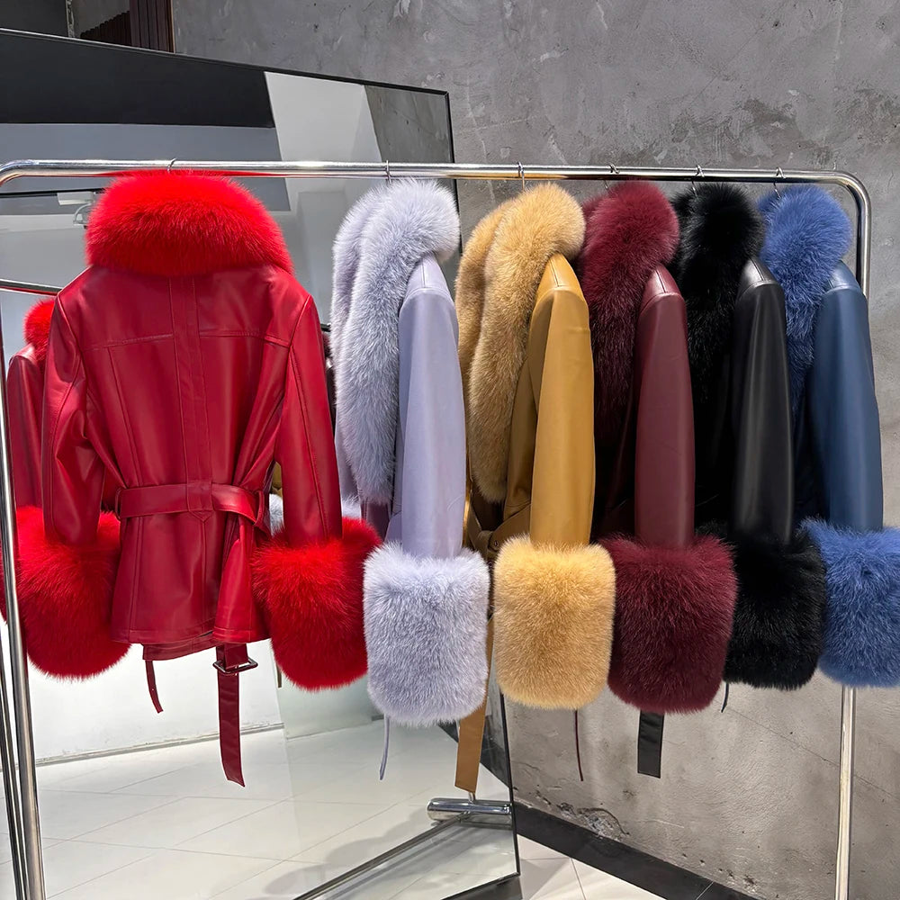 Collection of fur-trimmed jackets displayed on a rack against a gray wall.