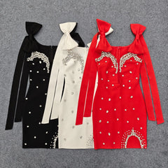 Assorted colors of embellished bow strap mini dresses laid flat
