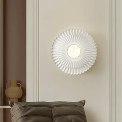 A round French retro wall sconce with a milk white glass lampshade, casting a soft glow on a bedside table. B