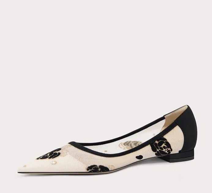 Black and white flat shoe on a light gray background