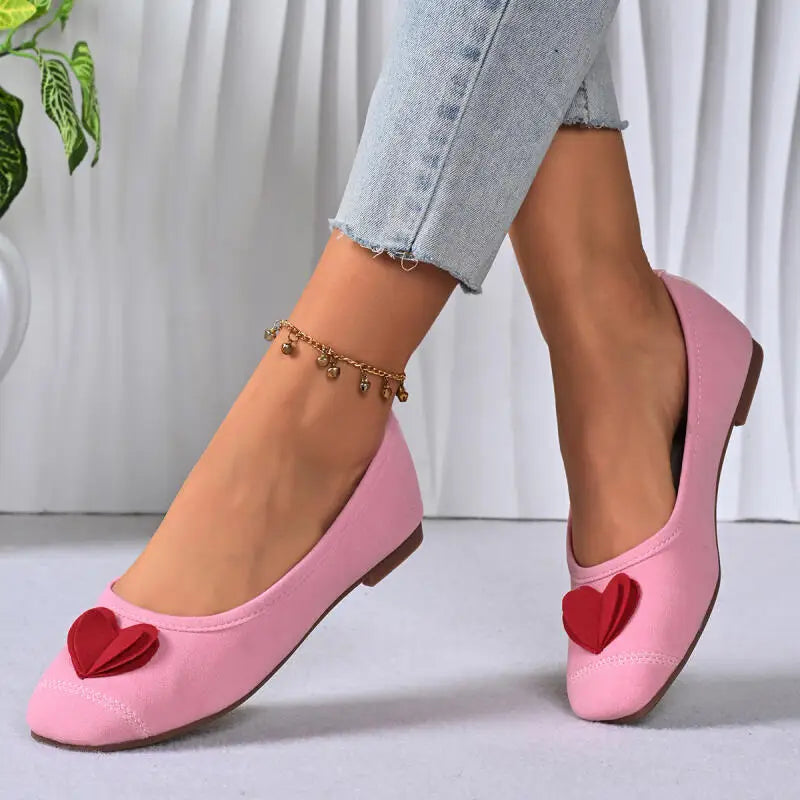 Model wearing pink ballet flats with jeans