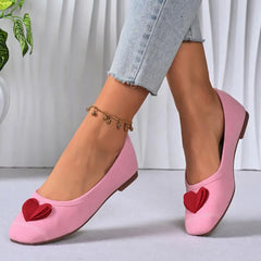Model wearing pink ballet flats with jeans