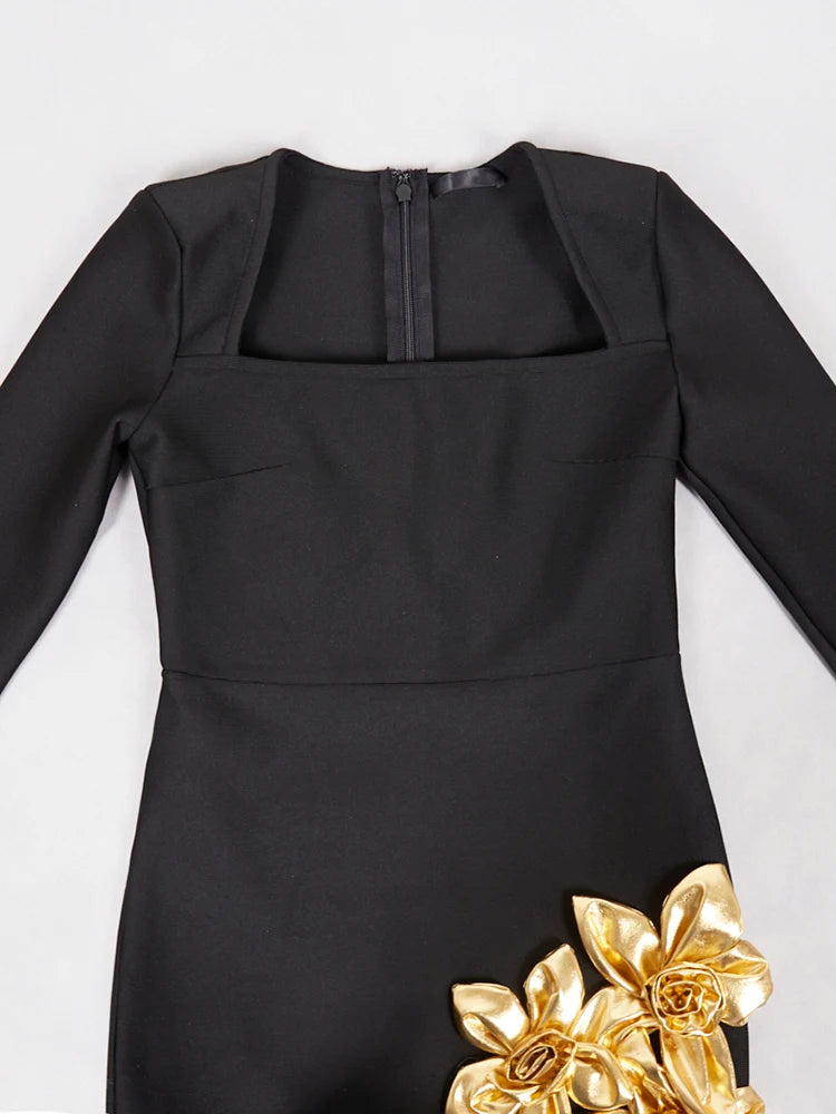 Black dress with gold floral details on a white background