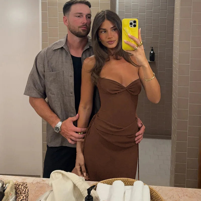 Man and woman taking a mirror selfie in a bathroom.