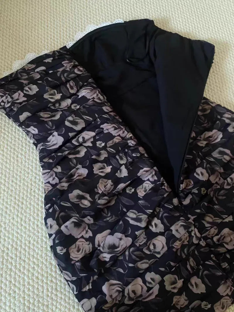 Floral-patterned fabric with black border on a textured surface