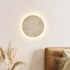  Natural yellow cave stone LED sconce with a warm glow, mounted on a bedroom wall. Golden Atelier 2