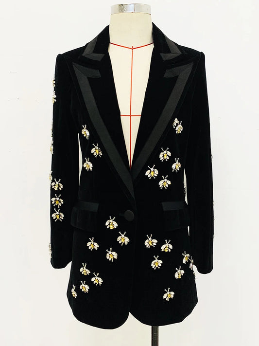 Black velvet blazer with beaded bee embellishments displayed on a mannequin.