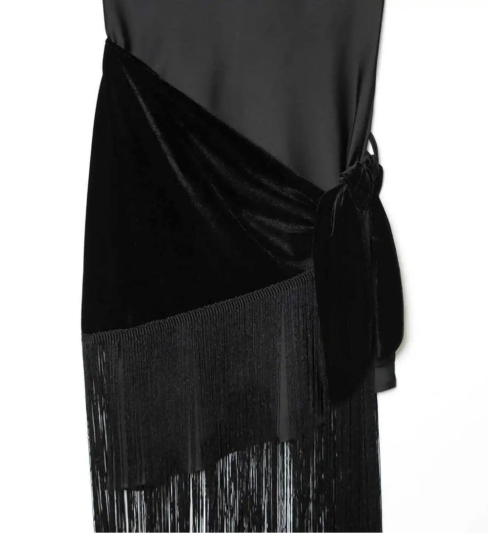 Black dress with fringe details on a white background