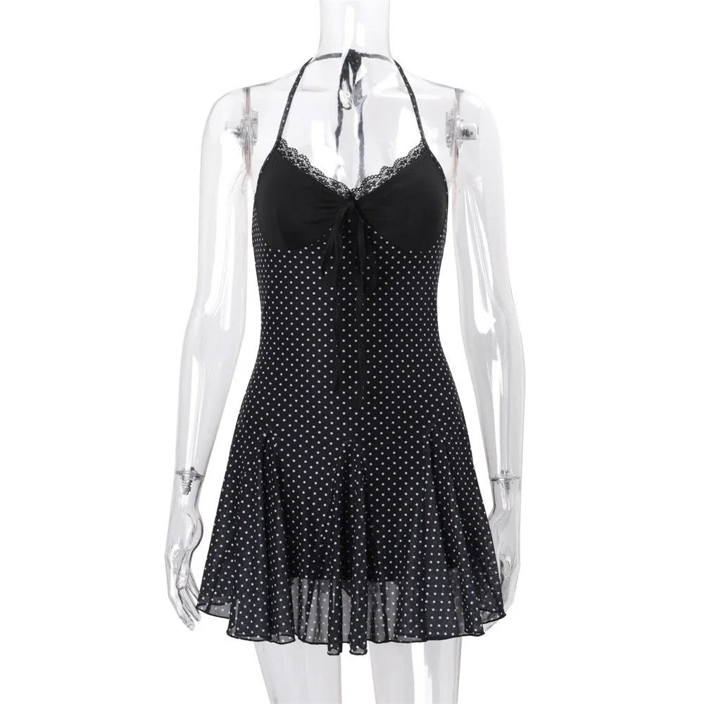 Black polka dot dress on a mannequin against a white background