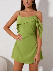 Green dress worn by a model against a neutral background