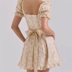 Floral dress with a bow detail on a plain background