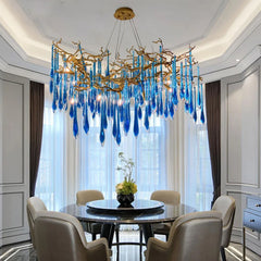 Luxurious dining room with a blue glass chandelier and round table.