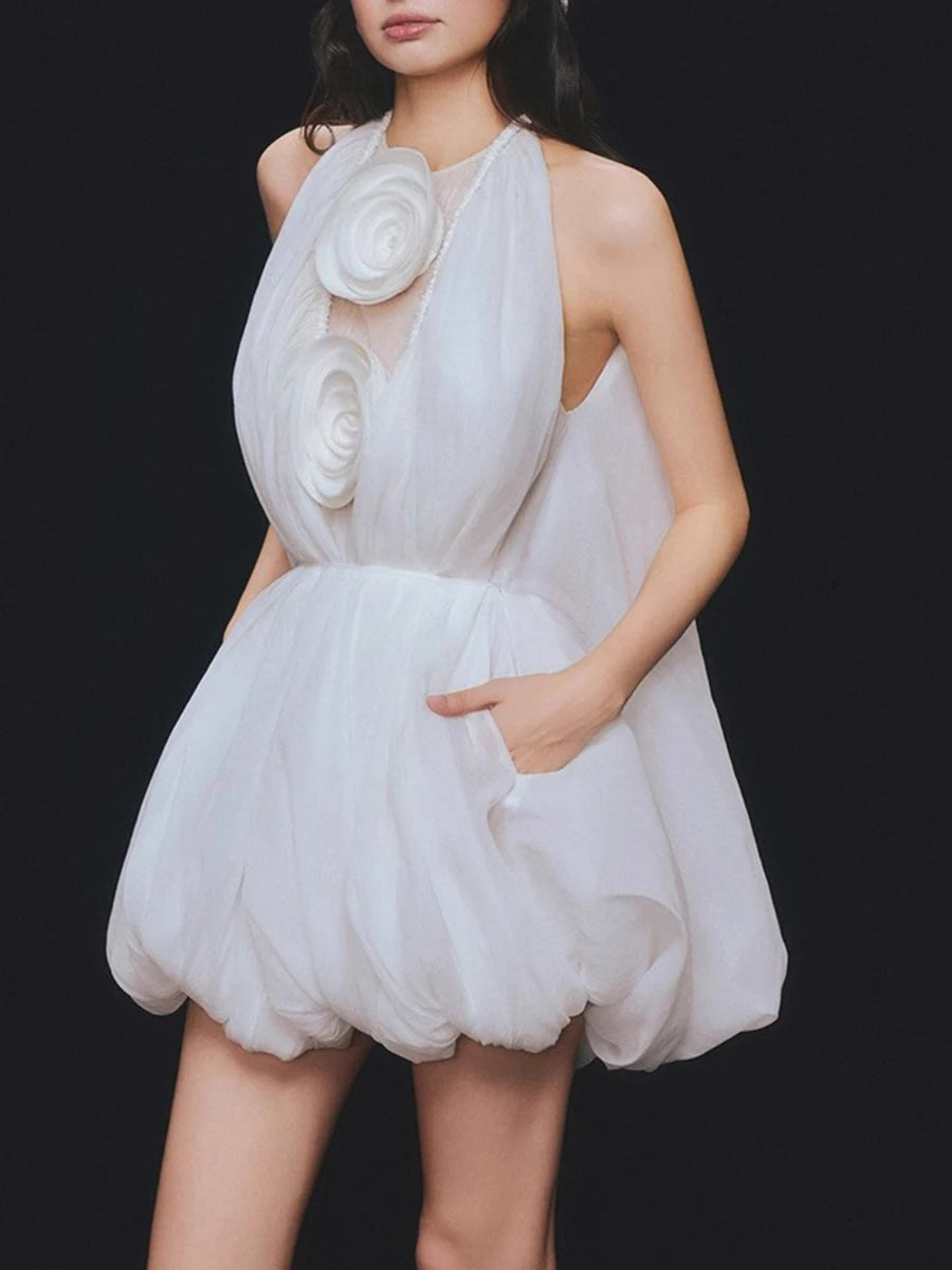 White dress with floral details on a black background