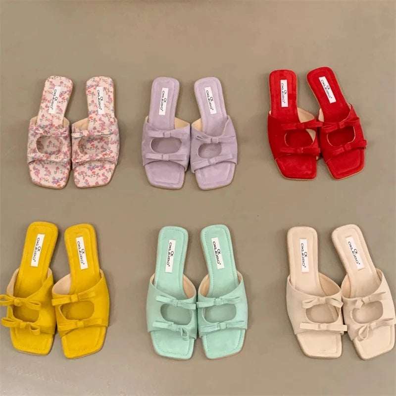 Set of colorful sandals arranged in a grid on a beige background