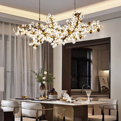 Modern chandelier hanging above a dining table in a stylish room.