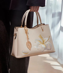 A woman wearing the embroidered shoulder bag, demonstrating its versatility and comfortable fit.