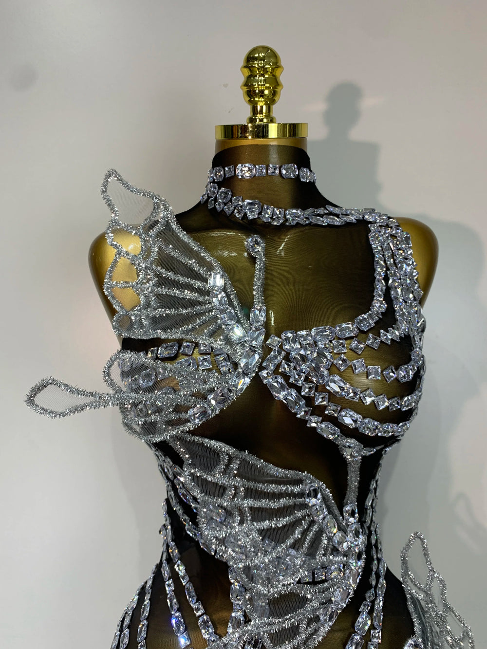 Close-up on the bodice of a crystal butterfly mini dress