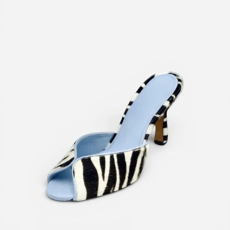 Leopard print peep toe mule heels on a white background