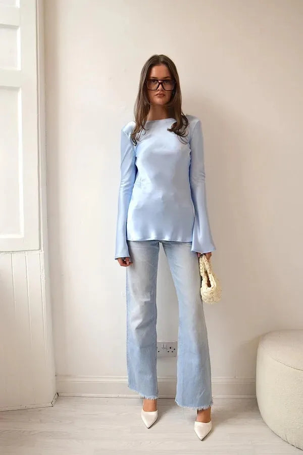 Woman wearing a light blue outfit with a white background