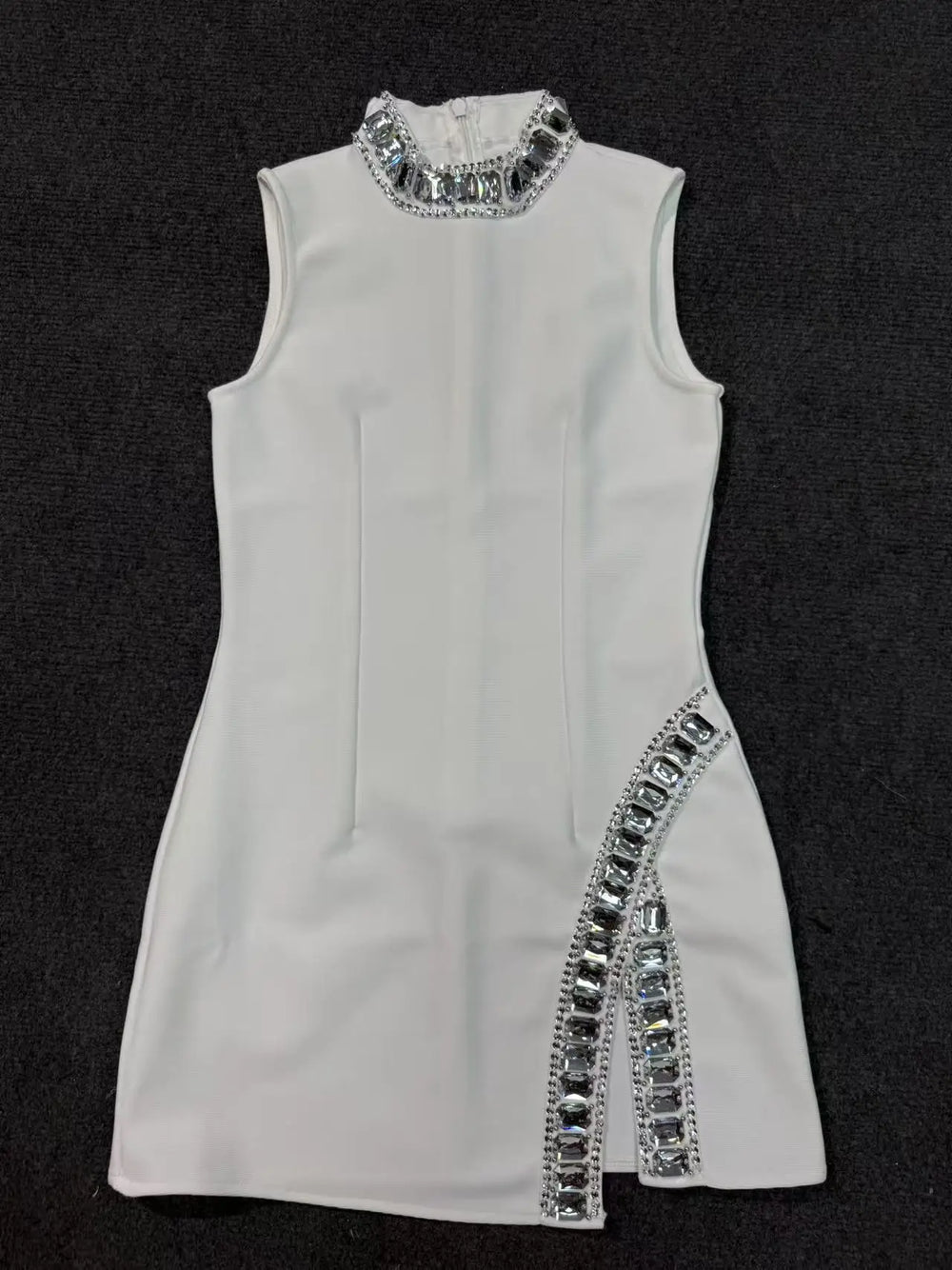 White dress with silver embellishments on a black background