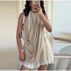 Close-up of a draped halter neck sleeveless top with gold jewelry