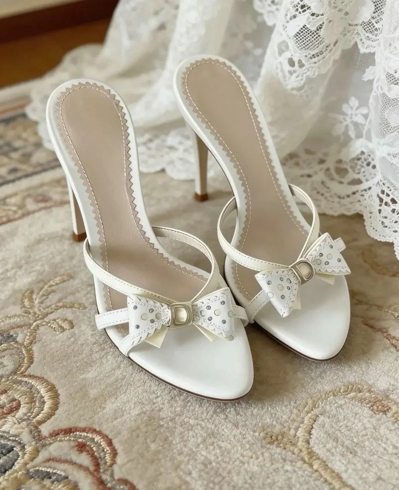 White bow accent heeled slides with stiletto heel