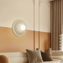 A round French retro wall sconce with a milk white glass lampshade, casting a soft glow on a living room sofa.. D