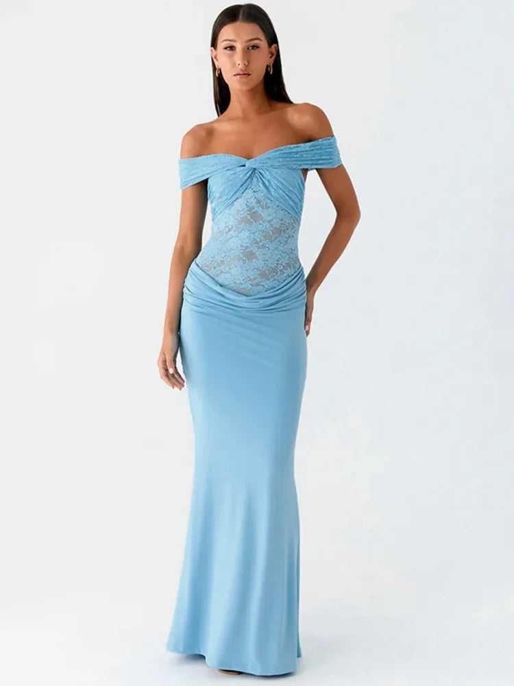 Woman wearing a light blue off-shoulder gown with lace detailing on a white background